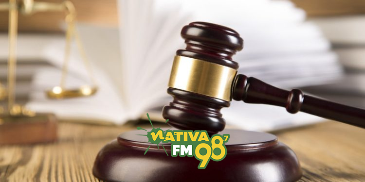 Golden scales of justice, gavel and books wood brown background